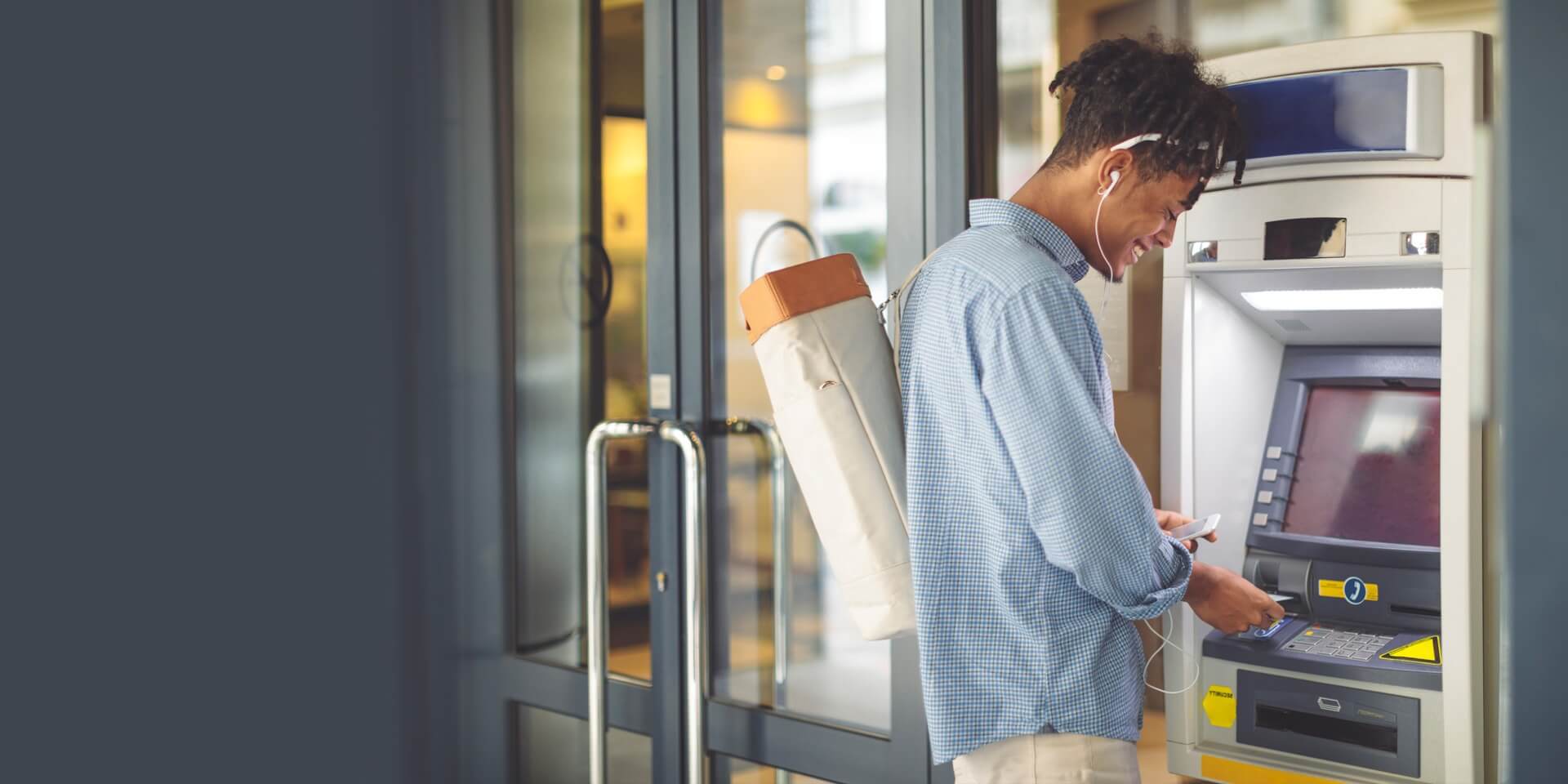 A client at an ATM getting cash form his account