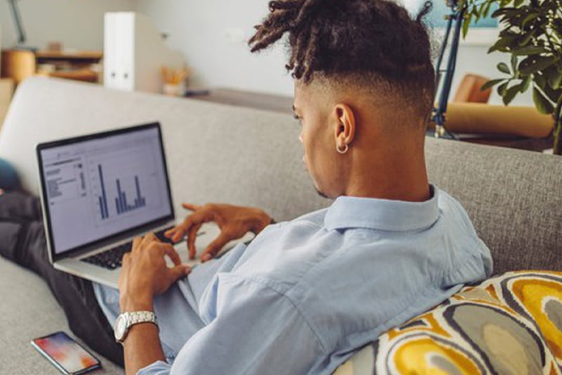 A man looking at his retirement goals on his laptop