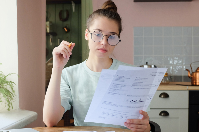 A young woman looking at her monthly budget