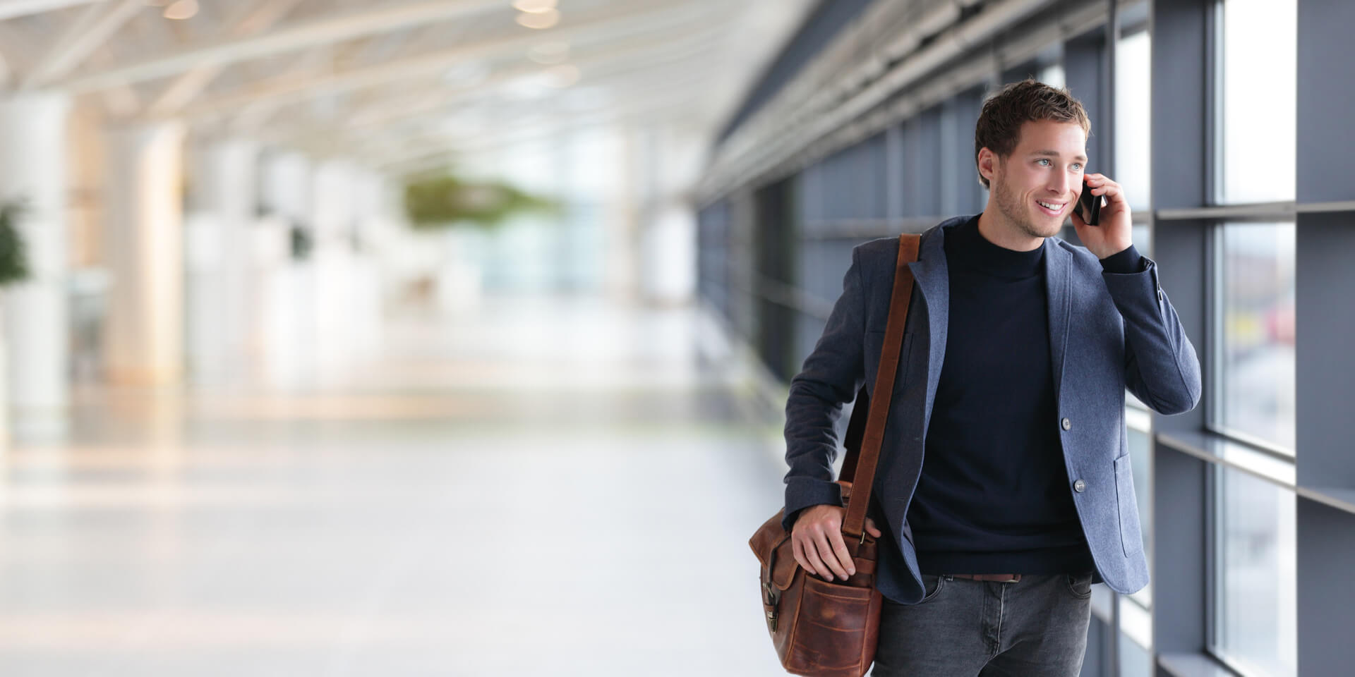 A man on his phone talking with a family member
