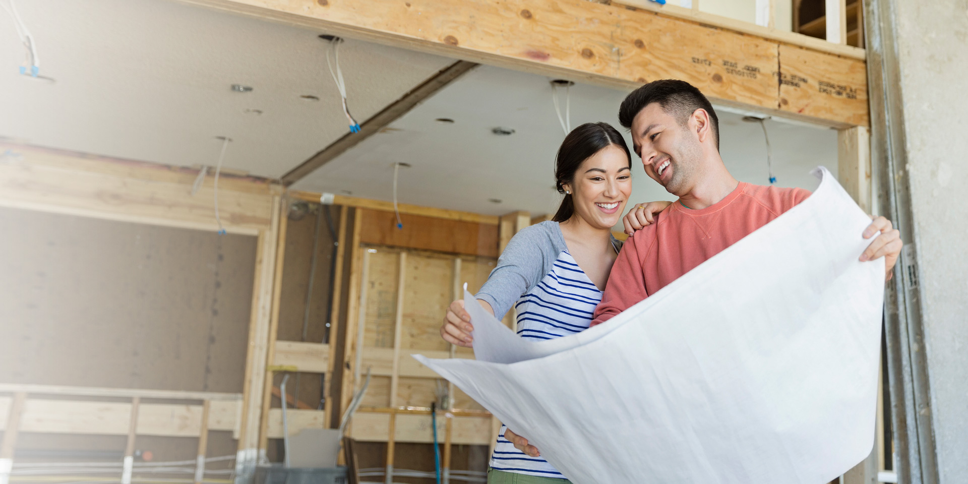 A couple looking at blueprints