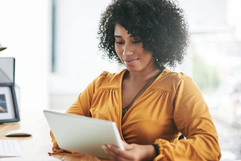 A woman on her tablet looking at a digital brocure