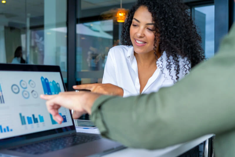 A meeting with two colleagues discussing financials