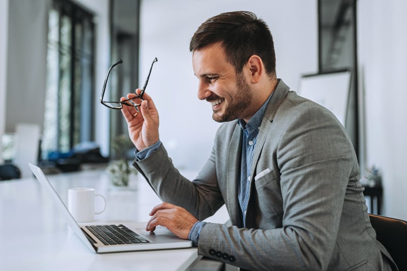 A man reading his emails on his laptop