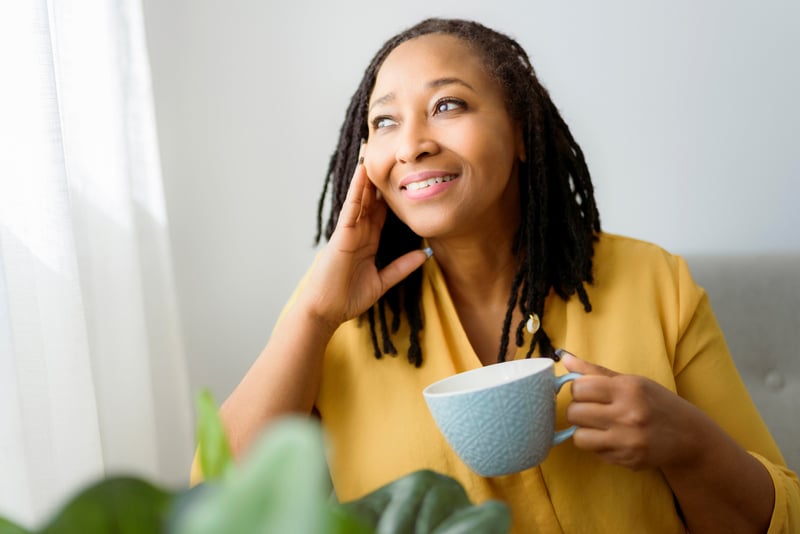 A woman drinking a cup of coffee