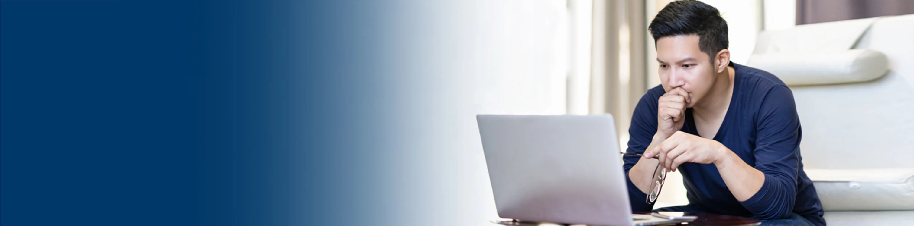 A man looking at information on his laptop