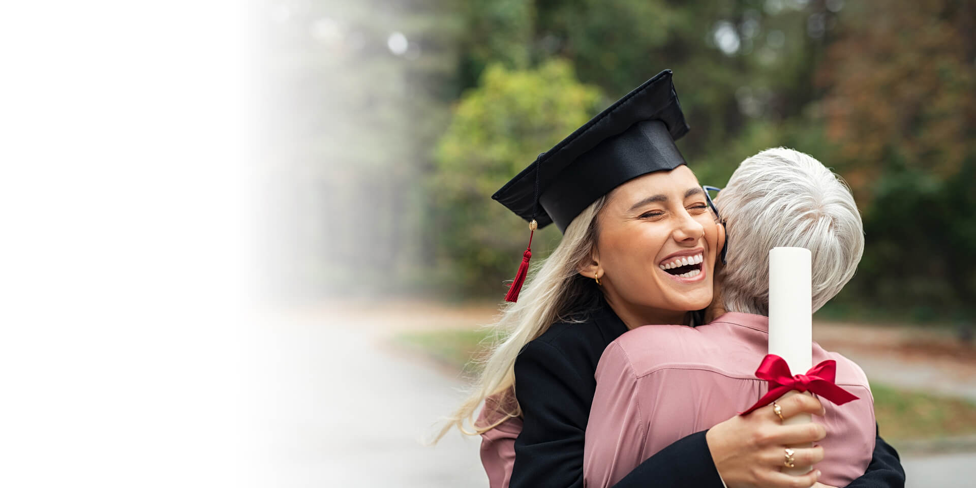 A college graduate hugging her grandma