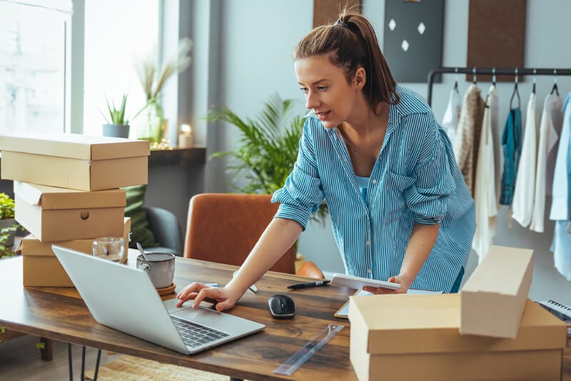 A woman looking at her laptop