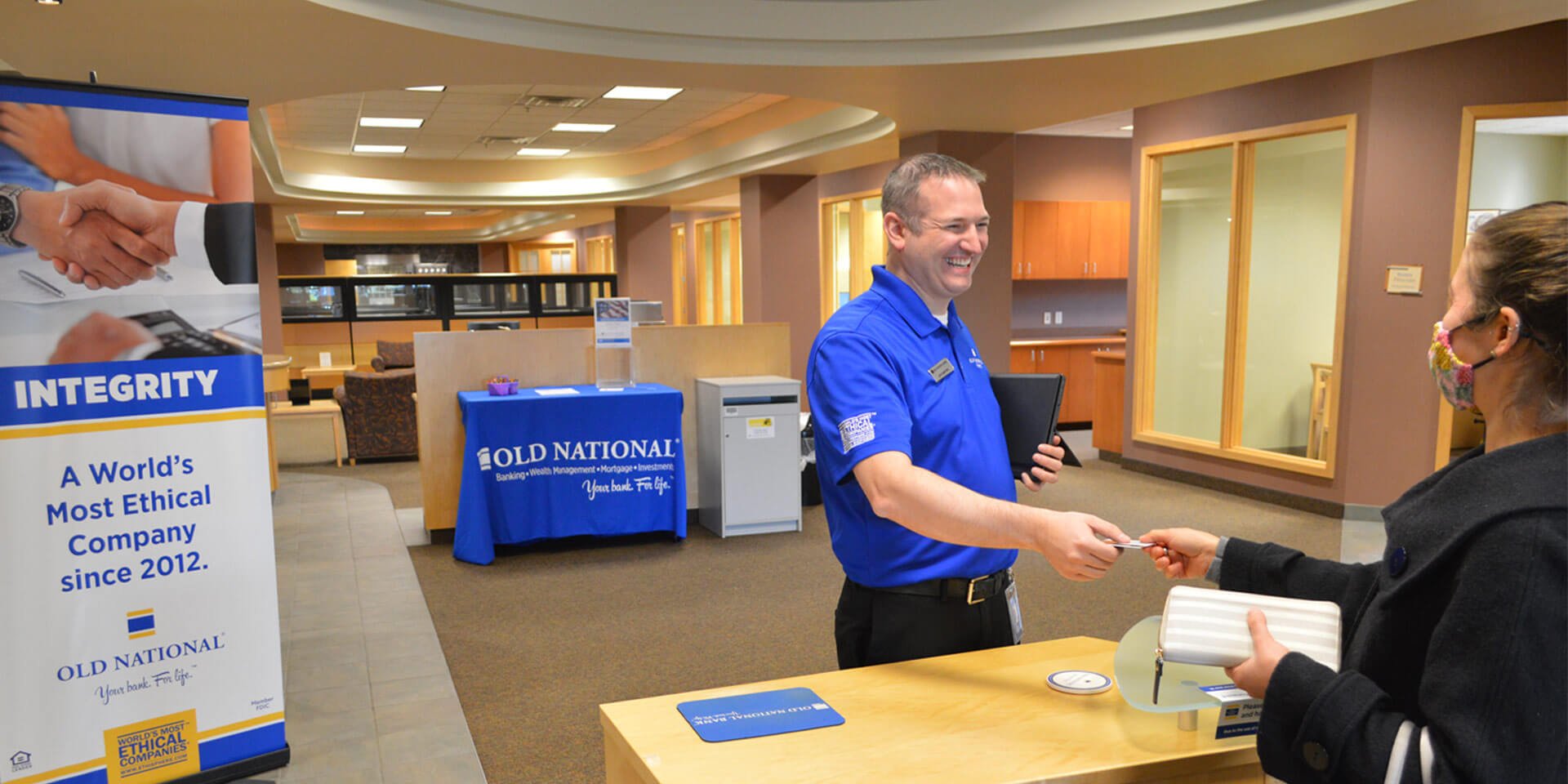 A banker at the branch greeting a customer