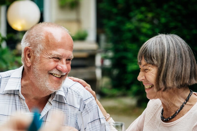 A couple outside laughing