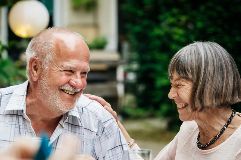 A couple outside laughing
