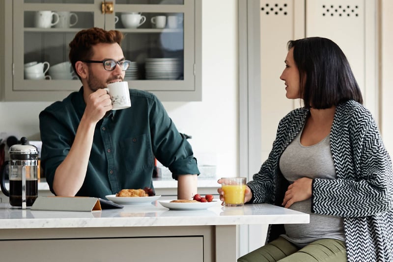 A couple in their kitchen talking about buying a home