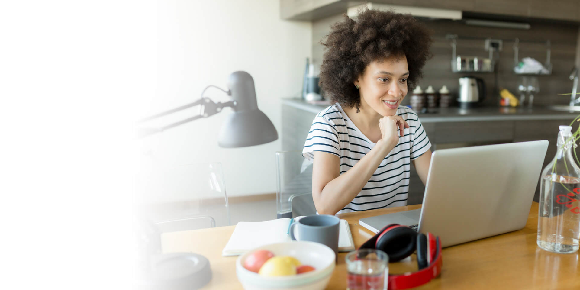 A woman at her laptop watching an instructional video