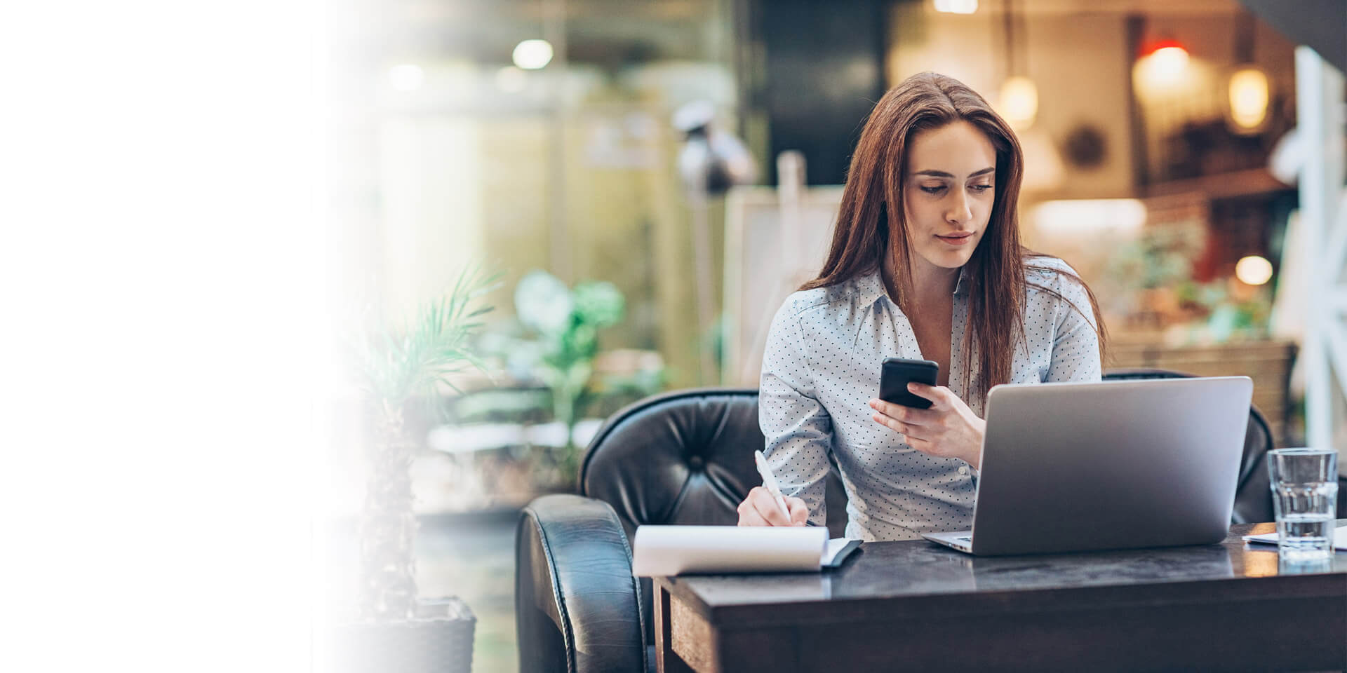 A woman at a desk checking her account