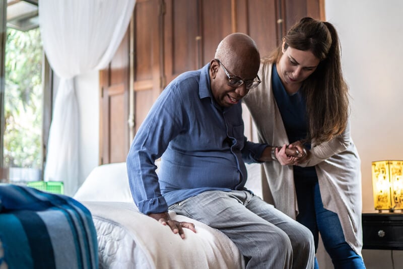 A nurse helping her patient