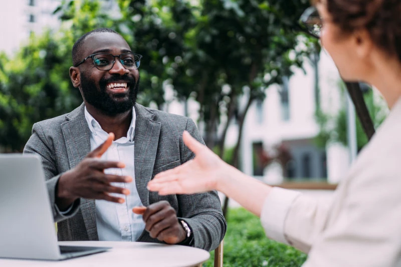 An associate about to shake a client's hand