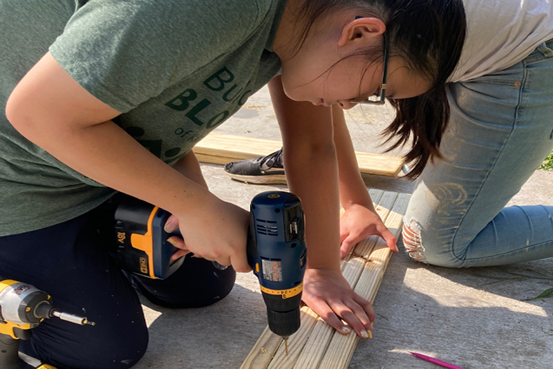 A teammate working on building a new house for someone in need