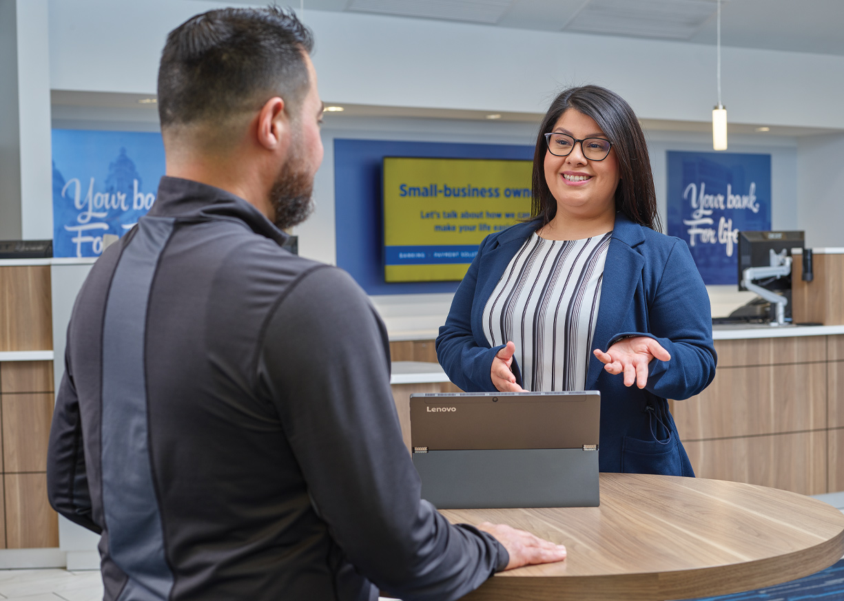 A banker assisting a client at her branch
