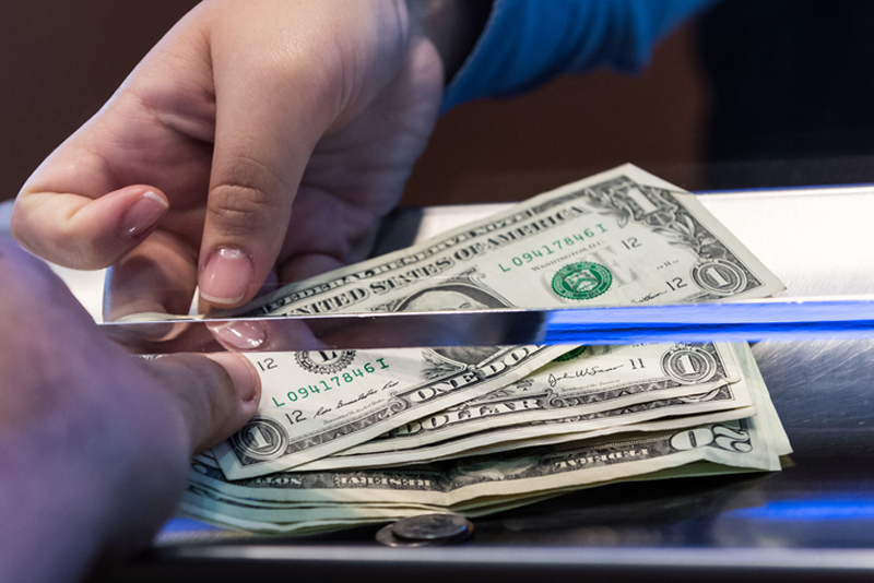 Handing money under a teller line glass