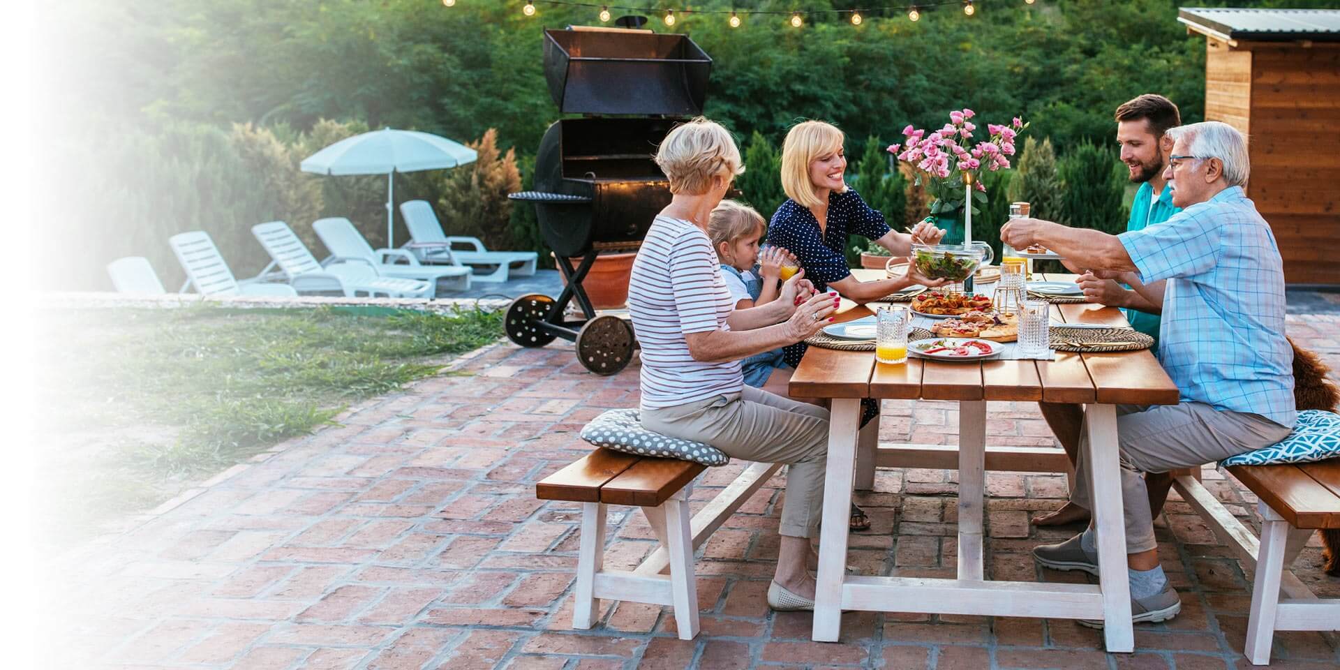 A family out on their patio having dinner